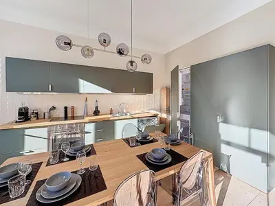 a kitchen with a table and a dining room at 66m2 Cosy appartement avec garage in Cannes