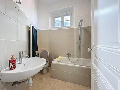 a bathroom with a sink and a toilet and a shower at 66m2 Cosy appartement avec garage in Cannes