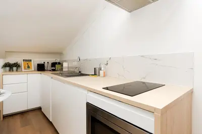 a kitchen with white cabinets and a counter top at Immogroom - 1 Bedroom - City Center - AC in Cannes