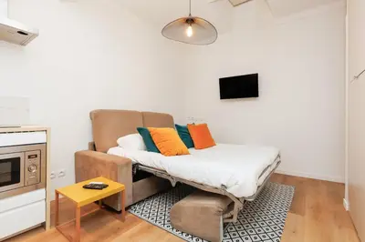 a living room with a couch and a tv at Immogroom - 1 Bedroom - City Center - AC in Cannes