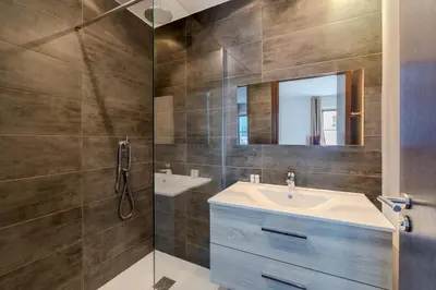 a bathroom with a sink and a mirror at Rue d Antibes 2ch, 2 SDB, clim, balcon in Cannes