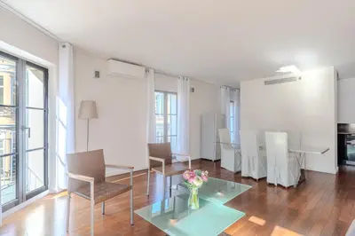 a living room with a glass table and chairs at Rue d Antibes 2ch, 2 SDB, clim, balcon in Cannes