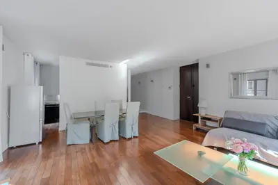 a living room with a table and a dining room at Rue d Antibes 2ch, 2 SDB, clim, balcon in Cannes