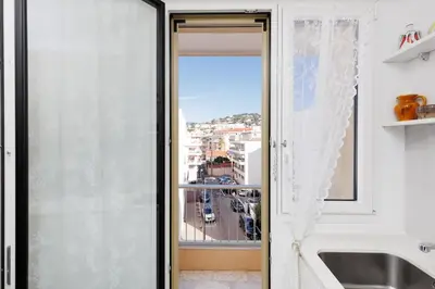a sliding glass door with a view of a city at Immogroom - Studio - Sea View - AC in Cannes