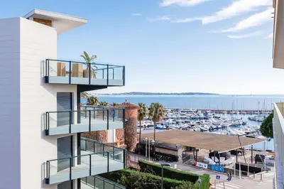 a building with balconies overlooking a marina at Immogroom - Studio - Sea View - AC in Cannes