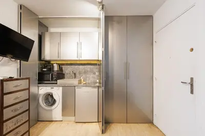a small kitchen with a washer and dryer at Immogroom – Stylish Studio – Beach 1 min away- AC in Cannes
