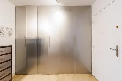 a closet with silver cabinets in a room at Immogroom – Stylish Studio – Beach 1 min away- AC in Cannes