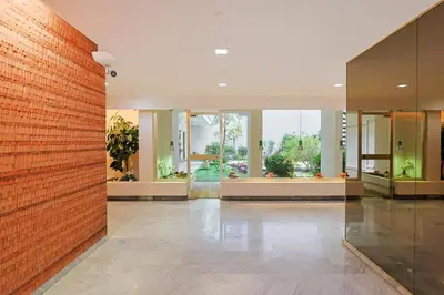 an empty lobby with a brick wall and windows at Immogroom – Stylish Studio – Beach 1 min away- AC in Cannes