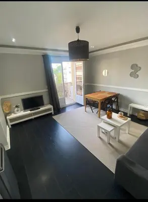 a living room with a table and a couch at Smart 3Apart- Cannes Le 62 in Cannes