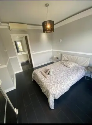 a bedroom with a bed and a chandelier at Smart 3Apart- Cannes Le 62 in Cannes