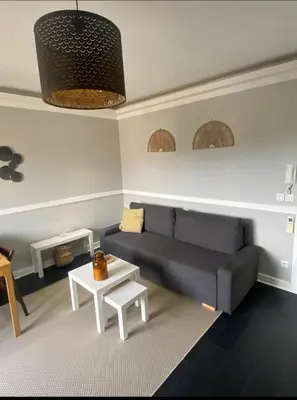 a living room with a blue couch and a table at Smart 3Apart- Cannes Le 62 in Cannes