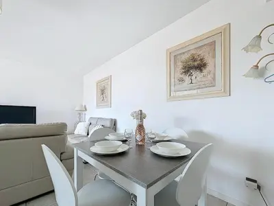 a dining room with a table and chairs at Appartement 3 pièces à Cannes avec piscine in Cannes