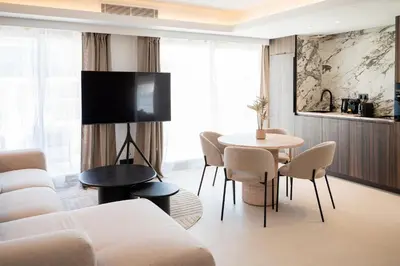 a living room with a couch and a table and chairs at Terrasse Vue Mer - 2BR - Parking - Croisette 50m in Cannes