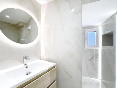 a white bathroom with a sink and a mirror at Repère des Artistes - central, 3mn from Beach, 10mn Palais, modern, AC, balcony in Cannes