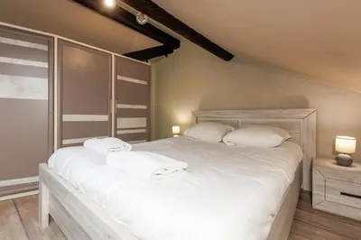 a bedroom with a large bed with white sheets and pillows at Immogroom - 2 Bedroom - Close to citycenter in Cannes