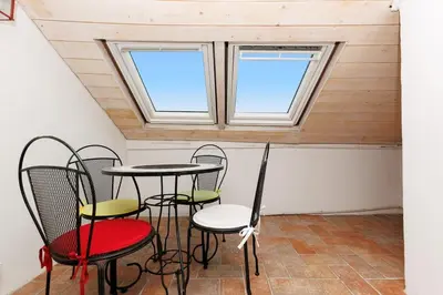 a room with three windows and a table and chairs at Immogroom - 2 Bedroom - Close to citycenter in Cannes