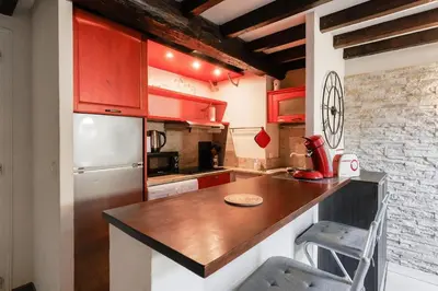 a kitchen with red cabinets and a white refrigerator at Immogroom - 2 Bedroom - Close to citycenter in Cannes