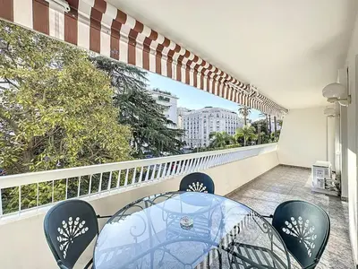 a balcony with a table and chairs on a balcony at Rue d'Antibes Victoria 2 rooms terrace - 2ES in Cannes