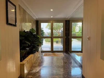 an empty hallway with doors and plants in a building at Rue d'Antibes Victoria 2 rooms terrace - 2ES in Cannes