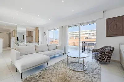 a living room with a couch and a table at 6 LECERF T5 - Apartment heart of Cannes 4 Bedrooms Terrace in Cannes