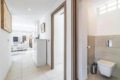 a white bathroom with a toilet and a sink at 6 LECERF T5 - Apartment heart of Cannes 4 Bedrooms Terrace in Cannes