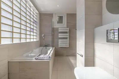 a bathroom with a tub and a toilet and a sink at 6 LECERF T5 - Apartment heart of Cannes 4 Bedrooms Terrace in Cannes