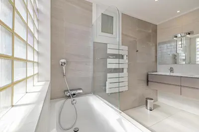 a bathroom with a bath tub and a sink at 6 LECERF T5 - Apartment heart of Cannes 4 Bedrooms Terrace in Cannes