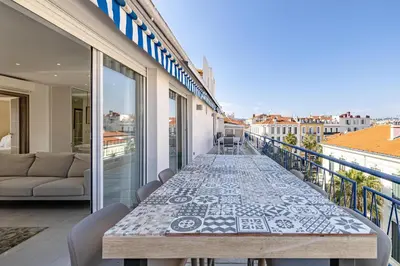 a table on a balcony with a view of the city at 6 LECERF T5 - Apartment heart of Cannes 4 Bedrooms Terrace in Cannes