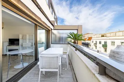 an apartment with a balcony with a table and chairs at 64 ANTIBES - Stunning 1-bedroom with terrace at Gray d'Albion in Cannes