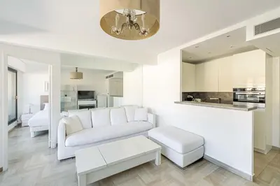 a white living room with a couch and a table at 64 ANTIBES - Stunning 1-bedroom with terrace at Gray d'Albion in Cannes