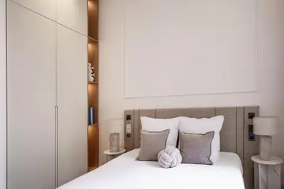 a bedroom with a bed with white sheets and pillows at 106 ANTIBES - Luxurious 4-bedroom apartment Rue d'Antibes in Cannes
