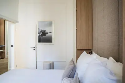 a bedroom with a white bed and a white door at 106 ANTIBES - Luxurious 4-bedroom apartment Rue d'Antibes in Cannes