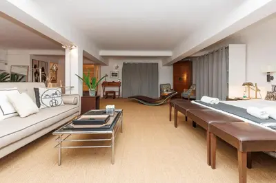 a living room with a couch and a table at Loft Gallia YourHostHelper in Cannes