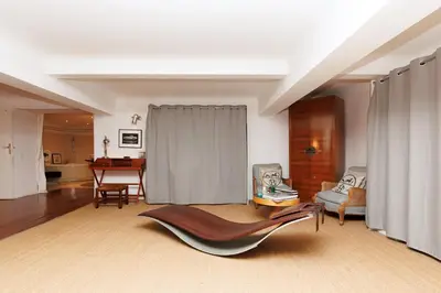 a living room with a couch and a chair at Loft Gallia YourHostHelper in Cannes