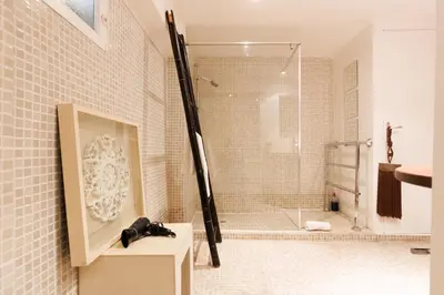 a bathroom with a shower with a glass door at Loft Gallia YourHostHelper in Cannes