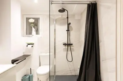 a bathroom with a shower with a toilet at Loft Gallia YourHostHelper in Cannes