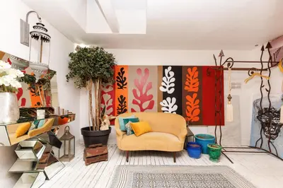 a living room with a yellow chair and a wall at Loft Gallia YourHostHelper in Cannes