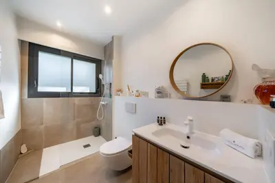 a bathroom with a sink and a toilet and a mirror at COZYSTAY 1827 - Beautiful 3-room apartment with large private terrace in Cannes