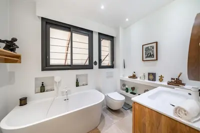 a white bathroom with a tub and a toilet at COZYSTAY 1827 - Beautiful 3-room apartment with large private terrace in Cannes