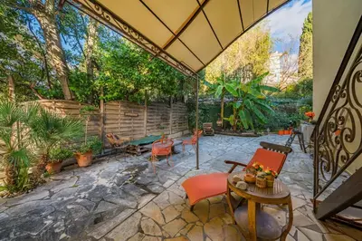an outdoor patio with chairs and a table at COZYSTAY 1827 - Beautiful 3-room apartment with large private terrace in Cannes