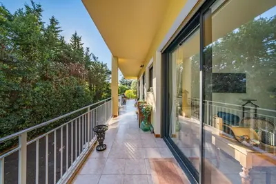 a balcony of a house with a view of the street at COZYSTAY 1827 - Beautiful 3-room apartment with large private terrace in Cannes