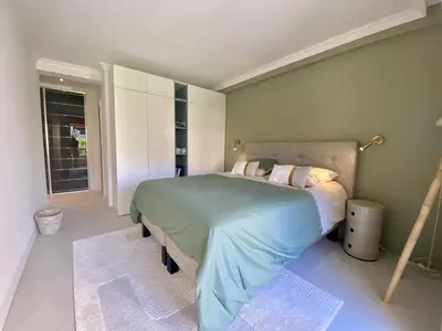 a bedroom with a large bed in a room at Cannes - Magnifique 4 pièces terrasse au calme à deux pas de la rue d'Antibes in Cannes