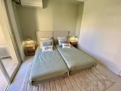 a bedroom with a bed with two pillows on it at Cannes - Magnifique 4 pièces terrasse au calme à deux pas de la rue d'Antibes in Cannes