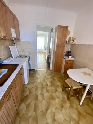 a small kitchen with a table and a table and a table at Cannes proche Croisette - 2 pièces lumineux in Cannes