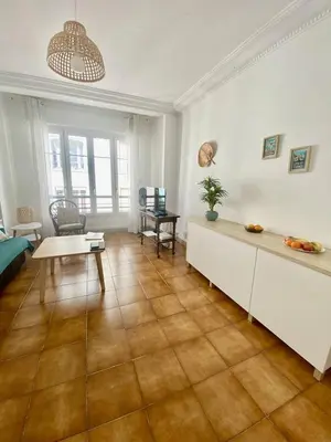 a living room with a table and a couch at Cannes proche Croisette - 2 pièces lumineux in Cannes