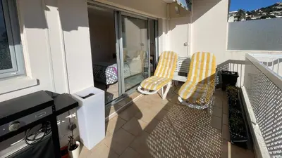 an apartment balcony with two chairs and a table at Chez Marilyne & Jean Baptise in Cannes
