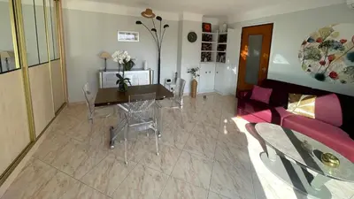a living room with a table and a couch at Chez Marilyne & Jean Baptise in Cannes
