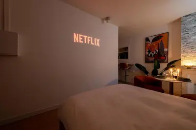 a hotel room with a netflix sign on the wall at Studio design au centre de Cannes proche Croisette climatisé in Cannes
