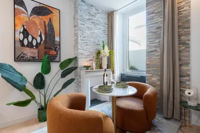 a living room with two chairs and a table at Studio design au centre de Cannes proche Croisette climatisé in Cannes