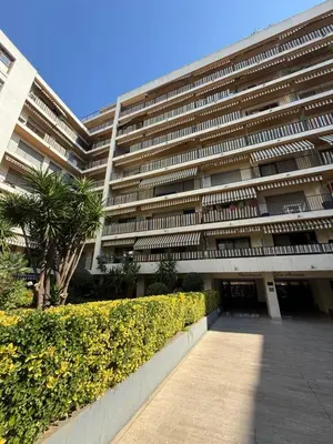 a large building with a sidewalk in front of it at Appartement studio avec terrasse in Cannes